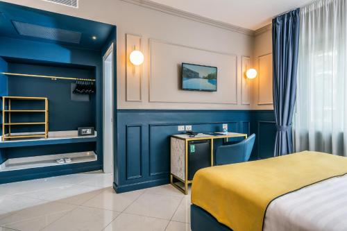 a hotel room with a bed and a desk at Hotel Mary in Vico Equense