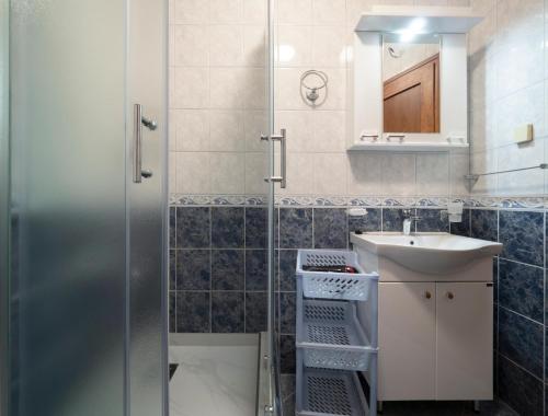 a bathroom with a shower and a sink at Apartments Marina in Sveti Stefan