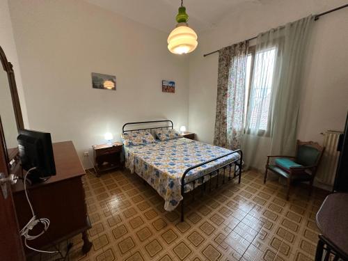 a bedroom with a bed and a tv in it at Laghetti di Corticella in Bologna