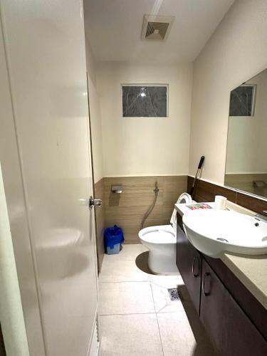 a bathroom with a toilet and a sink at Matina Enclaves Residences in Davao City