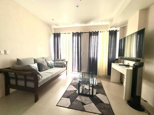 a living room with a couch and a table at Matina Enclaves Residences in Davao City