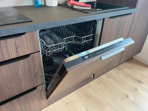 a dishwasher in a kitchen with a counter at Sun Apartments - with Dolomiten Panorama in Lienz