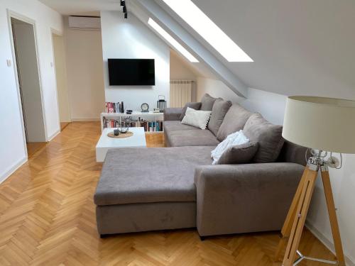a living room with a couch and a tv at Vila Pobeda in Banja Koviljača