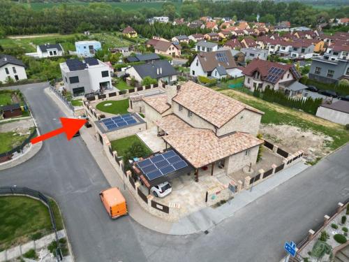 an aerial view of a house with solar panels on the roof at Prague West - Studio Chyne Terrace in Chýně