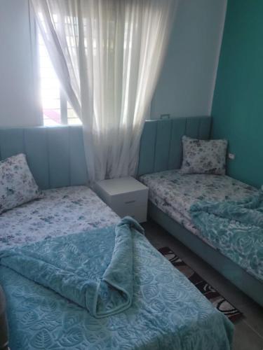 a bedroom with two beds and a window at Dar Z LeKbira in Tunis