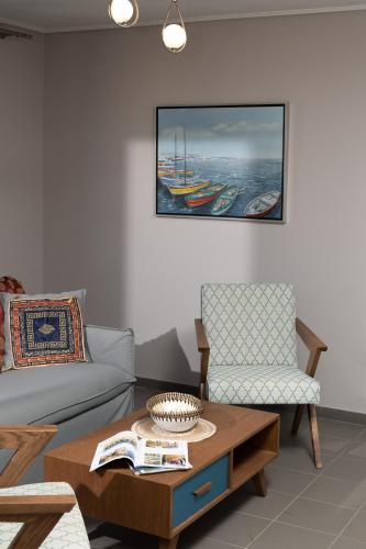 a living room with a couch and a coffee table at Lampetos Houses Molyvos in Mithymna