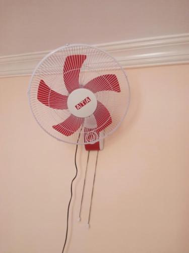 a fan is hanging on a wall at Youth Palace Hostel هوستل قصر الشباب in Alexandria
