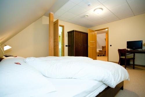 Ένα ή περισσότερα κρεβάτια σε δωμάτιο στο Hotell Räpina