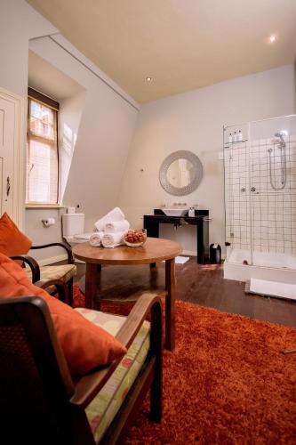 a living room with a table and a tub at Villa Margherita in Swakopmund