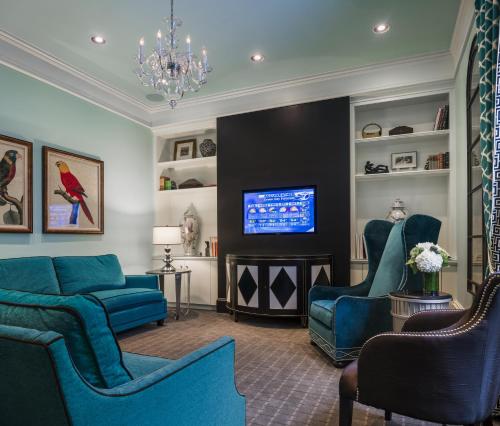sala de estar con muebles azules y TV en Seton Hotel, en Nueva York