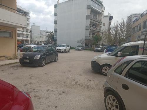 a bunch of cars parked in a parking lot at Stella's Apartment in Alexandroupoli