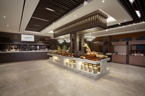 a store with a counter with candles in a lobby at Platinum Hotel Jimbaran Beach Bali in Jimbaran