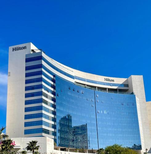 a tall building with a lot of windows at Tanger Hilton Penthouse 15 in Tangier