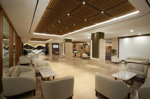 a waiting room at a hospital with chairs and tables at Platinum Hotel Jimbaran Beach Bali in Jimbaran