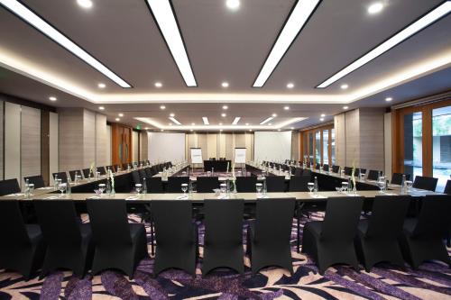 a large conference room with a long table and chairs at Platinum Hotel Jimbaran Beach Bali in Jimbaran