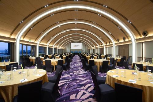 a large banquet hall with tables and chairs at Platinum Hotel Jimbaran Beach Bali in Jimbaran