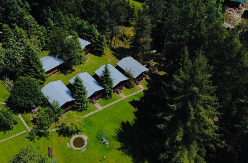 an overhead view of a group of houses with trees at Domki letniskowe pod Brzozami Stella in Polańczyk