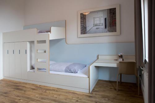 a bedroom with a bunk bed and a desk at Jugendherberge Berlin Ostkreuz in Berlin