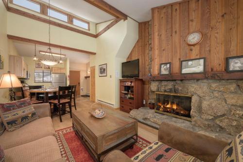 a living room with a fireplace and a dining room at Beaver Village Unit #0232R in Winter Park