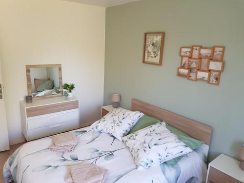 a bedroom with a bed with a mirror on the wall at La Barak'A in Saint-Laurent-sur-Mer