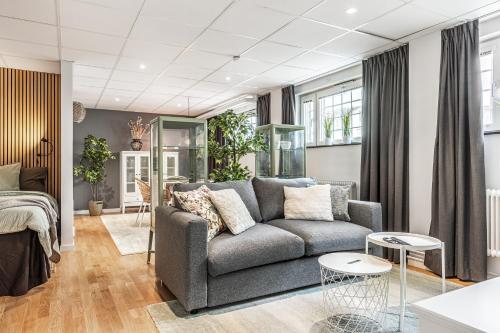 a living room with a couch and a bed at STORM studios in Karlskrona