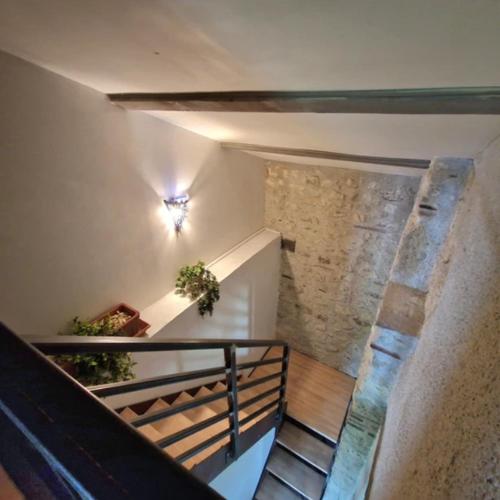 a staircase in a building with a stone wall at Hameau de capuran in Blaziert