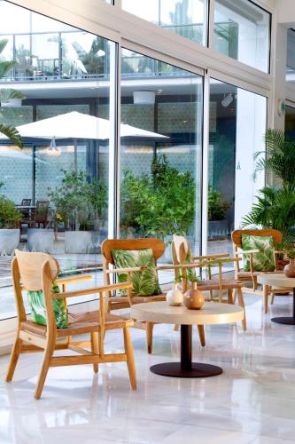 a group of chairs and a table in a building at Altafulla Mar Hotel in Altafulla