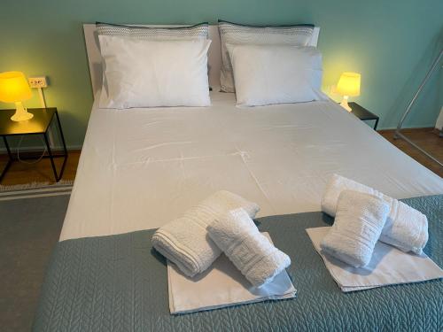 a bed with towels and pillows on it at Central Apartment with view in Edessa