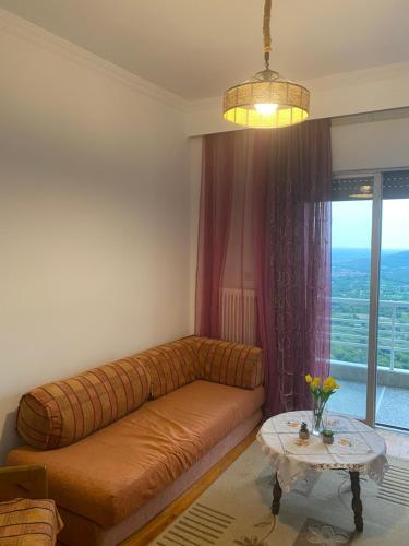 a living room with a couch and a table at Central Apartment with view in Edessa
