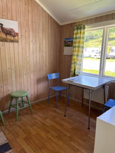 a room with a table and chairs and a window at Svindland Camping in Kvinesdal