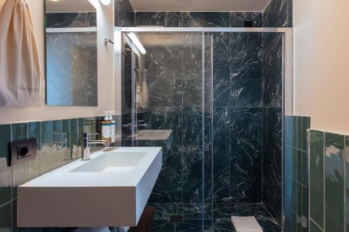 a bathroom with a sink and a shower at Numa Rome Barberini in Rome