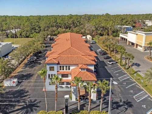 an aerial view of a building with a parking lot at Quality Inn Daytona Speedway - I-95 in Daytona Beach