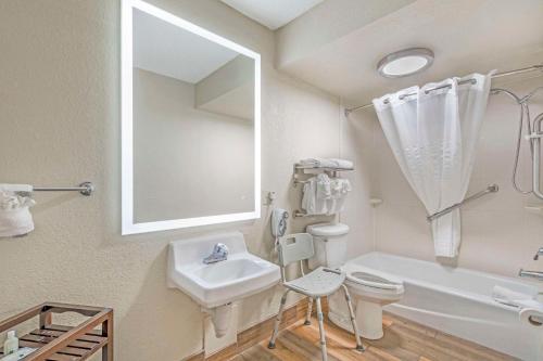 a bathroom with a sink toilet and a mirror at Quality Inn Daytona Speedway - I-95 in Daytona Beach