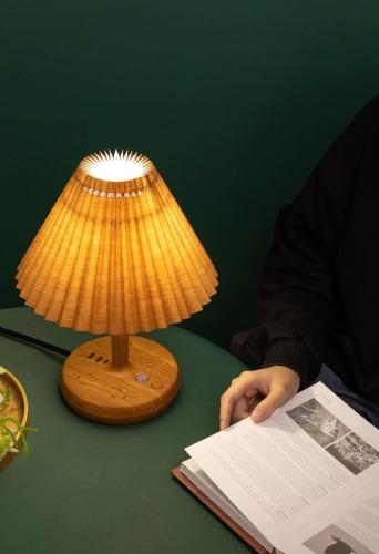 a lamp sitting on a table next to a book at Blue Haven Retreat - Glenmore Park Pool Home in Glenmore Park