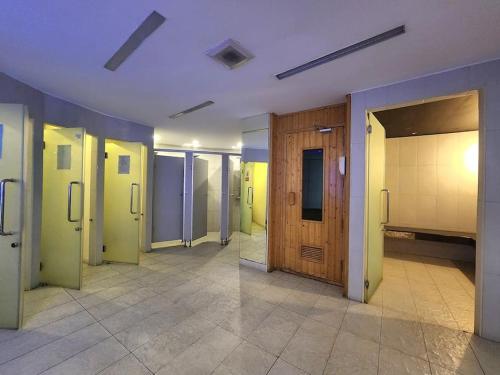a hallway of a room with doors and a tile floor at Unique studio in town in Pattaya Central
