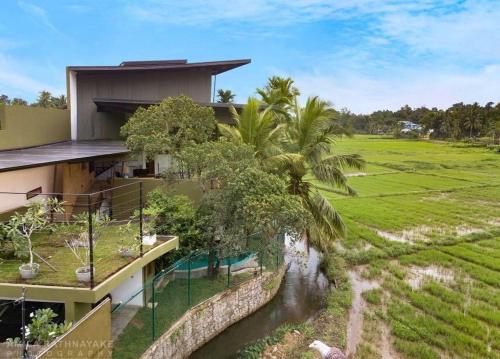 an aerial view of a house with a pool and a field at Villa 47 Colombo in Pannipitiya