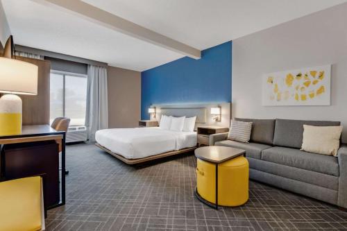 a hotel room with a bed and a couch at Comfort Suites Chesapeake - Norfolk in Chesapeake