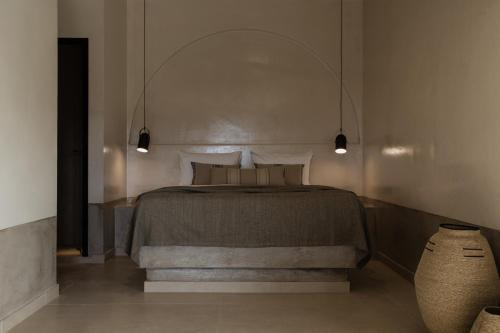 a bedroom with a bed and a vase at Momi Slow Living Hotel in Hersonissos