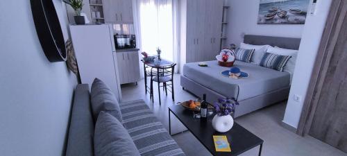 a living room with a couch and a table at Blue Lotus Studio in Agia Marina Nea Kydonias