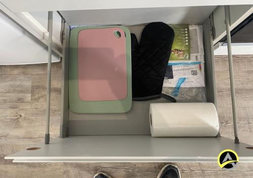 a cell phone is sitting on a shelf at Delightful London Chalet House in Bromley