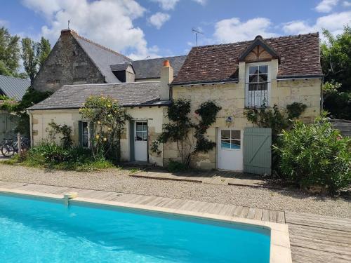 a house with a swimming pool in front of it at Maison au cœur des châteaux. in La Chapelle-aux-Naux