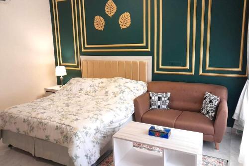 a small bedroom with a bed and a couch at Puri Sawo Manila in Jakarta