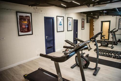 a gym with two tread machines in a room at Stil Hotel in Bucharest