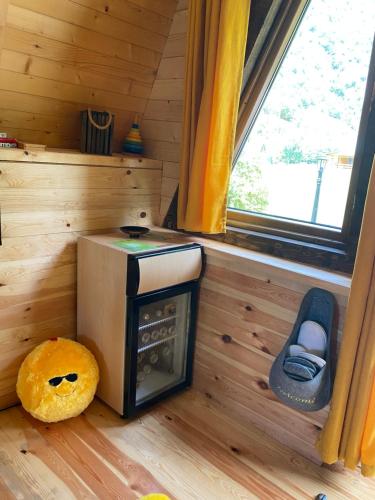 a small stove in a room with a window at Family S house - Komarnica in Šavnik