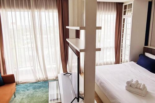 a cross in a room with a bed and a cross at Cosy SeaView, High Floor, free Netflix in Bangsaen