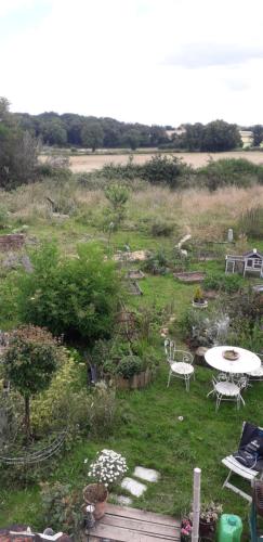 - un jardin avec une table et des chaises dans un champ dans l'établissement Naturart, à La Berthenoux
