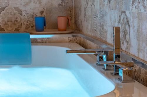 a bathroom with a bath tub with a sink at Vsuite livingchic in Cagliari