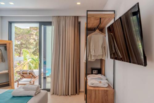 a bedroom with a bed and a sliding glass door at D PALM Premium Living - Kalathas, Chania in Chania Town