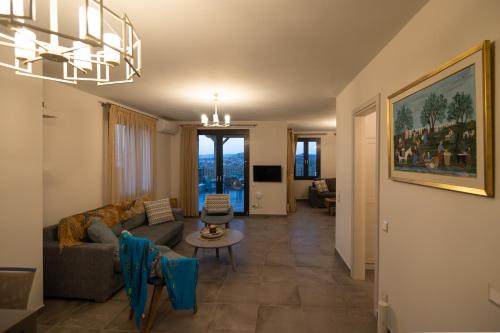 a living room with a couch and a table at Lampetos Houses Molyvos in Mithymna