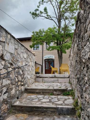a stone wall with stairs in front of a building at Affittacamere Ellera Verde in Villetta Barrea